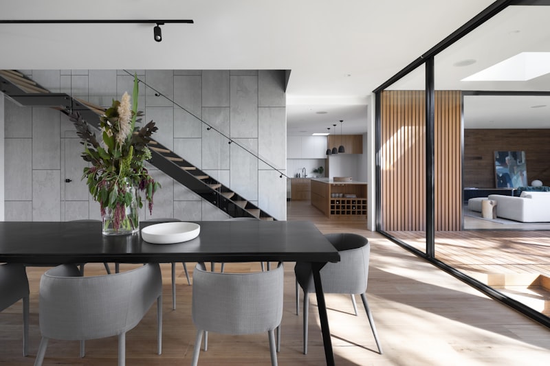 Dark modern architectural detail, sleek surfaces, rich textures, polished metal accents, ambient lighting, high resolution, no humans